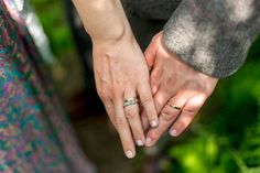 two people holding hands while standing next to each other