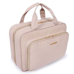 a pink bag with gold zippers on it