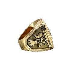 a gold ring with an emblem on the side and diamonds around it's edges