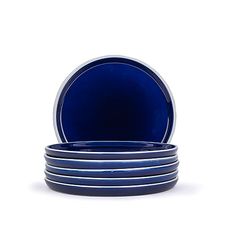 blue plates stacked on top of each other in front of a white background with no one around them