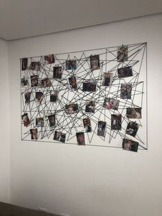 a white wall with pictures hanging on it