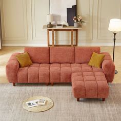 a living room scene with focus on the couch and rugs in front of it