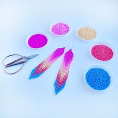 the beads are being sewn together to make beaded earrings with scissors and thread