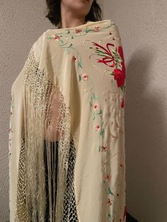 40s Vivid Floral Embroidered Silk Shawl. Fringed Ivory Piano Shawl circa 1940s, warp yourself with this luxurious Silk fabric with Hand Embroidered design. Embroidered bouquet of red roses on four corner of the shawl sides with beautiful green and ivory leaves, pink branches all over. silk knotted crochet and long fringe.  measurements taken while lying flat. 41" long by 41" width , fringe 20" (Approximately) Good vintage condition.  Etsy Shipping Please read -Vintage and pre-owned items may have signs of wear and use and are offered as is. Traces of age and use are therefore completely normal and do not constitute defects. Please see pictures as they are part of the item description and refer to sizes/measurements provided. measurements are taken Flat, double for circumference. Please con Luxury Vintage Silk Shawl, Vintage White Shawl Scarf, Fitted Vintage Shawl, Vintage Fitted Shawl For Wedding, Fitted Vintage Shawl For Wedding, Vintage Embroidered Shawl For Spring, Embroidered Bouquet, Bouquet Of Red Roses, Piano Shawl