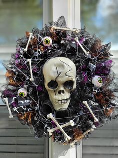 a skeleton wreath with eyes and bones on the front door