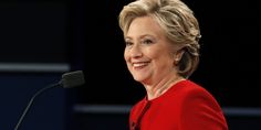 a close up of a person at a podium with a microphone in front of her