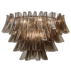 a large chandelier made out of glass and metal strips on the bottom half of it