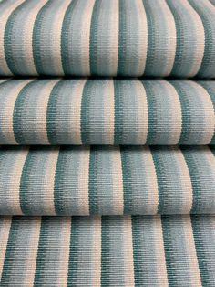 four blue and white striped fabric stacked on top of each other