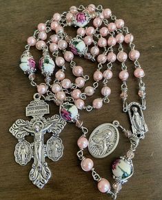 "This beautiful handmade rosary is made with 6mm pink  glass beads, 8mm ceramic beads and 2\"  crucifix.   Length: 20\" inches long" Adjustable Pink Rosary Bracelet With 8mm Beads, Pink Spiritual Jewelry With 8mm Beads, Handmade Pink Rosary With Round Beads, Handmade Pink Rosary Bracelet With Round Beads, Pink Beaded Spiritual Rosary, Pink Rosary With Miraculous Medal As A Gift, Pink Rosary With 8mm Round Beads, Pink Rosary With 8mm Beads As Gift, Pink Rosary With 8mm Beads For Gift