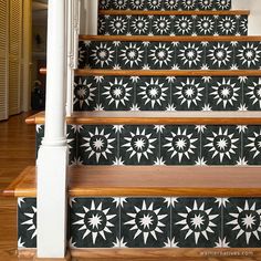 the stairs are decorated with black and white tiles