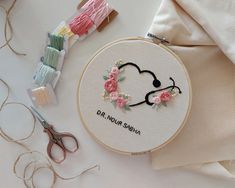 the embroidery kit is next to scissors and thread