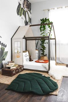 a bedroom with a bed, rug and plants