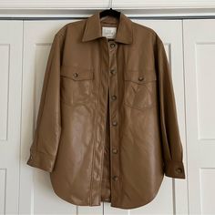 New With Tags The Wilfred Ganna Faux Leather Shacket From Aritzia. This Is In The Color Saville. Size Small. Super Soft And Chic. Retail $168. Measures Approximately 21.5” From Armpit To Armpit And 30.5” From Shoulder To Hem. Face: 100% Polyurethane Back: 100% Polyester Lining: 100% Cupro Final Sale. Price Is Firm. Fall Leather Jacket With Faux Front Pockets And Collar, Fall Collared Leather Jacket With Faux Front Pockets, Long Sleeve Outerwear With Faux Front Pockets For Fall, Spring Leather Button-up Outerwear, Leather Button-up Spring Outerwear, Chic Collared Outerwear With Faux Pockets, Chic Button-up Leather Jacket For Fall, Brown Lapel Collar Shacket For Spring, Chic Winter Leather Jacket Button-up