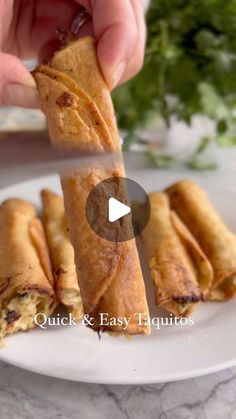 a person is holding up some food on a plate with the words quick and easy taquitass