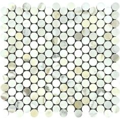 a white and silver mosaic tile with circles on the bottom, in various sizes and colors