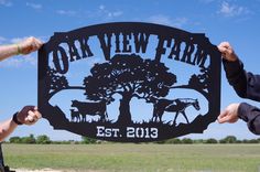 two men holding up a metal sign that says oak view farm est 2013 on it