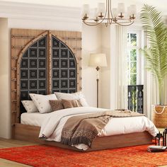 a bedroom with a bed, dressers and lamps on either side of the bed