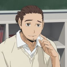 a man sitting in front of a book shelf