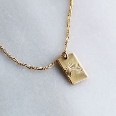 Our sun ray rectangle pendant necklace is a daily reminder to shine bright! Wear it alone or layer, it makes a great gift too! •Thick 19mm rectangle.•Choose your chain style.•100% 14kt Gold-Filled or Sterling Silver.•Stamped by hand with a sun ray Model is wearing 18 inch in photos & layered with our Unity Necklace Water friendly Rectangle Gold Necklace, Necklace Pendant Design, Rectangle Pendant Necklace, Rectangle Necklace, Preppy Jewelry, Sun Necklace, Rectangle Pendant, Square Necklace, Sun Pendant