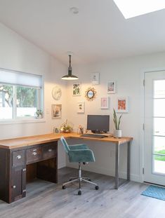 a desk with a computer on top of it next to a door and window sill