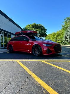 a red sports car parked in front of a building