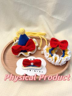 three crocheted hair accessories on a wooden tray