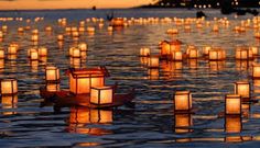 many lit candles floating in the water