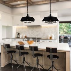 three lights hanging over a kitchen island with stools