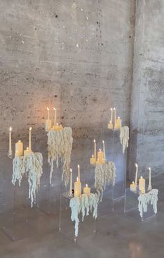 several candles are arranged in the shape of sheeps with horns and tails on them