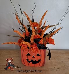 there is a fake pumpkin with flowers in it