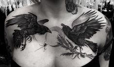 a woman with tattoos on her chest and two birds