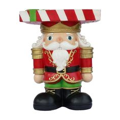 a christmas nutcracker ornament with a candy cane on it's head