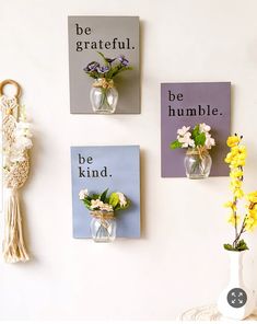 three vases with flowers are hanging on the wall next to two small cards that say be grateful and be kind