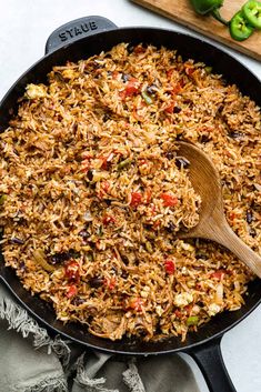 a skillet filled with rice and vegetables