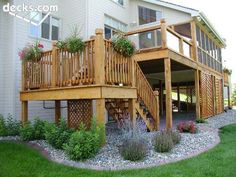 a wooden deck sitting on top of a lush green field