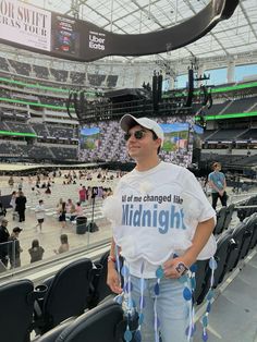 a man standing in the middle of a stadium wearing a t - shirt that says, if one changed his midnight