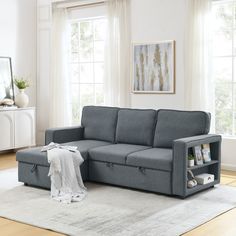 a living room scene with focus on the sectional sofa and storage unit in the foreground