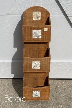 three wooden boxes are stacked on top of each other