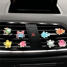 car air freshener holder with colorful fish and crab decorations on it's dashboard