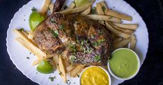 a white plate topped with french fries and meat