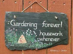 a garden sign hanging on the side of a wooden fence that says gardening forever housework whenever