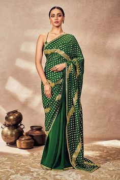 Emerald green crushed saree crafted in crepe silk with all over Palmscape foil print, gota embellishments and embroidered borders. Paired with sleeveless blouse embellished with embroidered border and kinari. - Aza Fashions Green Georgette Saree With Bandhani Print, Green Bandhani Print Traditional Wear, Green Bandhani Print Pre-draped Saree For Eid, Festive Green Bandhani Pre-draped Saree, Traditional Green Draped Saree, Traditional Green Draped Dupatta, Traditional Green Draped Blouse Piece, Sweetheart Neck, Printed Sarees