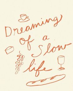 the words dreaming of a slow life written in red ink on a white paper background