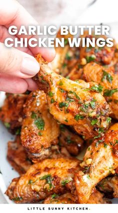 garlic butter chicken wings in a white bowl with text overlay that says garlic butter chicken wings