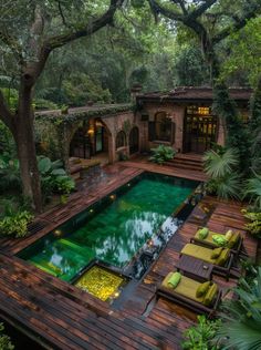 an outdoor pool surrounded by greenery and trees in the middle of a yard area