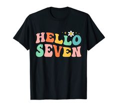 a black t - shirt with the words hello seven printed in multicolored letters