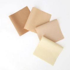 three different colors of fabric on a white surface, one beige and the other light brown