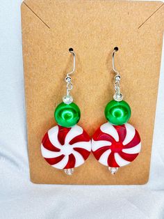 Large Christmas Peppermint Earrings  Peppermint is Acrylic  Green bead is acrylic  Small crystal bead Green Beaded Earrings For Holidays, Green Beaded Earrings For Christmas Party, Christmas Holiday Round Bead Earrings, Christmas Holiday Round Beaded Earrings, Christmas Party Earrings With Round Beads, Christmas Party Round Bead Earrings, Christmas Party Round Beads Earrings, Handmade Green Beaded Christmas Earrings, Handmade Green Beaded Earrings For Christmas