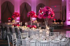 the tables are set with silver linens and pink flowers