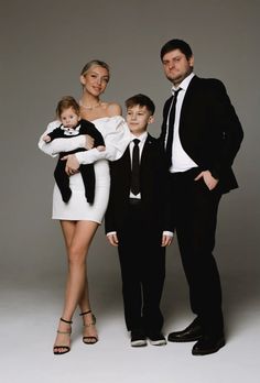 a man, woman and two children posing for a photo